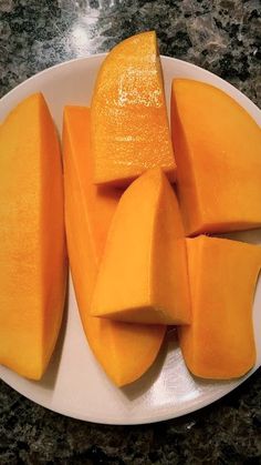 a white plate topped with cut up mangoes