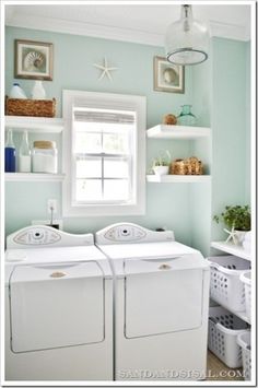 a white washer and dryer sitting next to each other in a laundry room