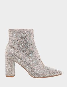 The CADY is a disco ready bootie that will take any outfit you wear to the next level. These ankle boots feature a pointed toe and a study, block heel and is fully decked out with rhinestones. Glitz and glam has never looked better. Heel height- 3.25 " Shaft height- 6", Circumference- 9.25", measured on a size 6 Allover rhinestone detailing Soarkle Boots, Disco Wedding Dress Sparkle, Sparkly Ankle Boots, Sparly Boots, Silver Sparkly Boots, Sparkly White Boots, White Sparkly Boots, Disco Shoes Women, Sparkle Boots Outfit