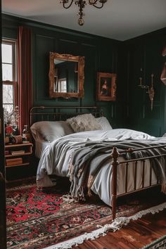 a bedroom with dark green walls and wooden flooring is furnished with an antique style bed