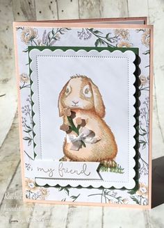 a card with a bunny holding a flower