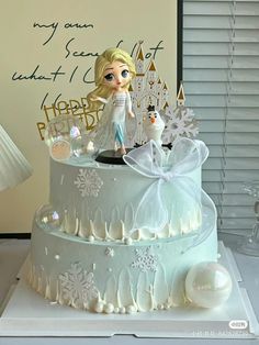 a frozen princess cake with frosting and decorations