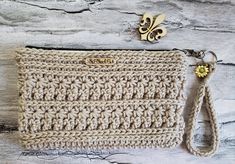 a crocheted purse with a keychain attached to the front and side