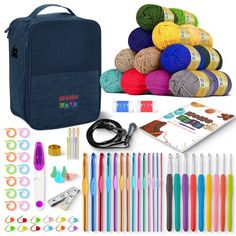 crochet supplies including yarn, scissors and knitting needles in a blue bag with the contents laid out