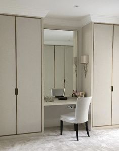 a white chair sitting in front of a desk with a mirror on top of it