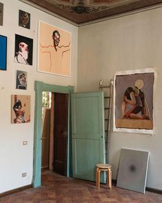 a room with pictures and paintings on the wall