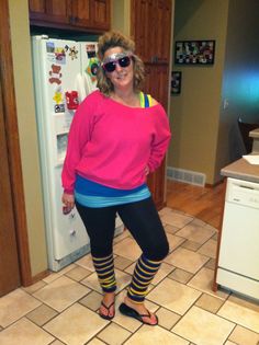 a woman standing in front of a refrigerator wearing leggings and sunglasses with her hands on her hips