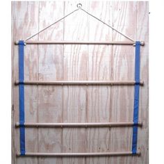 a wooden wall with blue straps hanging from it's sides and the bottom part of its frame