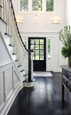 an entryway with black and white decor