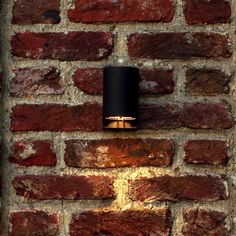 a brick wall with a lamp on it