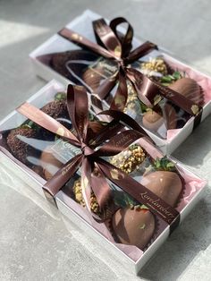 two boxes of chocolate covered strawberries tied together