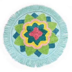 a circular rug with fringes on it in the shape of a flower and leaves