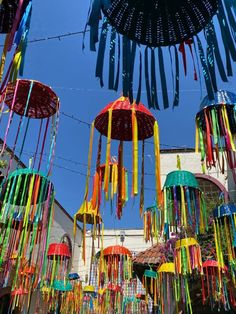 many colorful umbrellas are hanging in the air