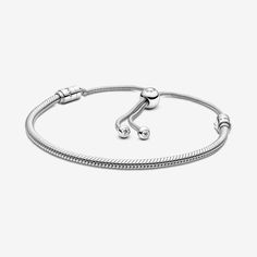 This stunning snake chain bracelet is a sophisticated spin on the classic friendship bracelet. Hand-finished in polished sterling silver, it features one movable and one fixed end cap — both set with shimmering stones. An innovative sliding clasp makes it easy to adjust it to your size. The perfect present for friends and loved ones, this bracelet can be styled by lifting the movable end cap and adding your favorite Pandora charms. Pandora Moments Snake Chain Slider Bracelet - Size 11 In Charm | Charms Disney, Charms Pandora, Slider Bracelet, Bracelet Pandora, Snake Chain Bracelets, Pandora Silver, Disney Stitch, Star Bracelet, Pandora Bracelets