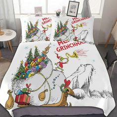 a bed covered in christmas themed sheets and pillows