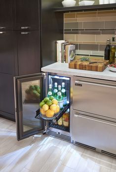 an open refrigerator in a kitchen filled with fruits and vegetables next to a counter top