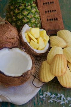 a pile of sliced up pineapple next to some cut up bananas and other fruit