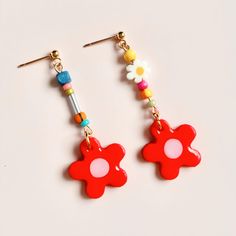 Warm welcome to my shop  Add a pop of colour to your look with these cute, mini handmade daisy dangle earrings! 🌸 Daisy Colour: Twilight Mint 🌸 Materials: Lightweight polymer clay earrings with assorted beads, 316L surgical stainless steel gold studs, front side coated with resin. 🌸 Drop length: 5cm (length vary slightly by a few mm) 🌸 Width: 1cm (at it's widest) 🌸 The beads alongside the daisy will vary slightly in colour and size, making your pair truly unique! 🌸 Each pair comes an organza pouch and care instructions. 🌸 Beads from Miyuki Factory in Japan (miyukifactory.com). 🌸 Note: Because each of my items is lovingly handmade, you might notice a few tiny imperfections or a slightly wobbly daisy. These little quirks make every piece one-of-a-kind and gives it a unique charm.  Th Trendy Drop Flower Earrings, Multicolor Flower Charm Drop Earrings, Adjustable Multicolor Earrings With Flower Charm, Adjustable Multicolor Flower Charm Earrings, Trendy Adjustable Flower Drop Earrings, Playful Red Drop Earrings, Whimsical Multicolor Flower Charm Earrings, Retro Multicolor Flower Earrings For Gift, Retro Flower-shaped Earrings For Gift