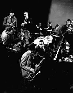 a black and white photo of men playing instruments