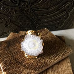 Make a statement with this oversized, adjustable raw solar quartz cigar ring. Solar quartz is cut from stalactites and is usually white, gray or colorless. When it is cut, you can see concentric circles in a radiating pattern and the center may reveal druzy, small quartz crystals, or air bubbles. The unpolished, raw stone has a 24k gold electroplated edge and is set on an adjustable gold-electroplated cigar band ring. The stones vary in shape and size but all are similar and measure about 1 inch Drusy Jewelry, Boho Rings Gold, Rings Boho, Raw Crystal Ring, Bohemian Style Jewelry, Druzy Jewelry, Bohemian Jewellery, Jewellery Rings, Organic Jewelry