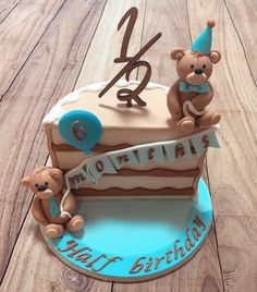 a birthday cake with two teddy bears on top and the number twenty five in the middle