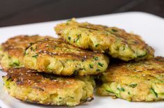 several crab cakes on a white plate ready to be eaten