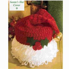 a crocheted santa hat with holly leaves on it