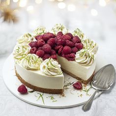 a cheesecake with raspberries and whipped cream