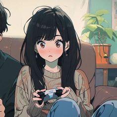 two people sitting on a couch holding game controllers