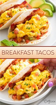 two breakfast tacos on a white plate with avocado and salsa in the background