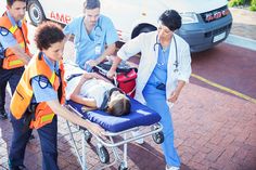 medical personnel tend to an injured person on a stretcher