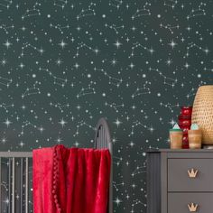 a baby's room with stars on the wall and a crib next to it