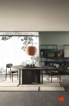 a modern dining room with an oval table and chairs