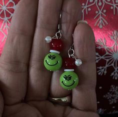 Celebrating the Christmas season is merrier with these whimsical Grinch earrings!  Made with cute Christmas Grinch face beads, glass beads, ceramic beads and stainless steel ear wires.  They are lightweight, and make a great Christmas gift or stocking stuffer! All of my jewelry is designed and handmade in my home jewelry studio.  I ship all jewelry in boxes, not bubble mailers, and every item comes in a drawstring bag and gift box. Grinch Earrings, Diy Earrings Dangle, Grinch Face, Christmas Grinch, Jewelry Holiday, Holiday Earrings, Earrings Christmas, Skull Jewelry, Holiday Earring