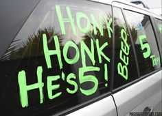 a car that has been vandalized with neon green writing on the side window