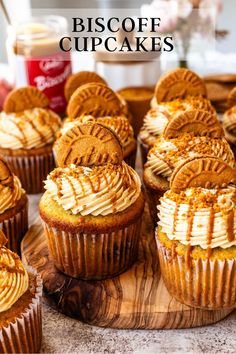 some cupcakes with frosting and peanut butter on top are sitting on a cutting board