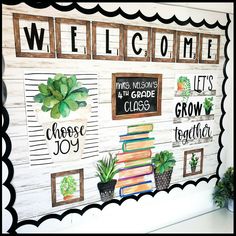 a welcome sign with books and succulents painted on it's side