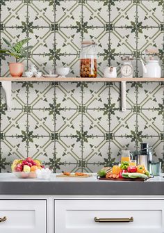 the kitchen counter is full of fresh fruits and vegetables, along with some cups on it