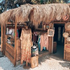 a store with straw roof and clothes on display