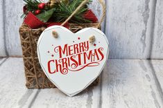 a heart shaped sign with the words merry christmas on it