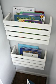 a white shelf with books and magazines in it