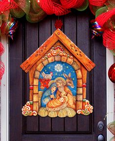 a christmas nativity scene is displayed on the front door