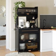 a kitchen area with a black cabinet and white counter top, potted plant in the corner