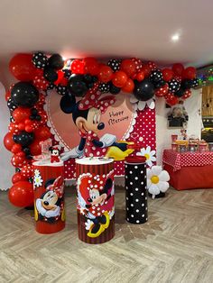 a mickey mouse birthday party with balloons and decorations