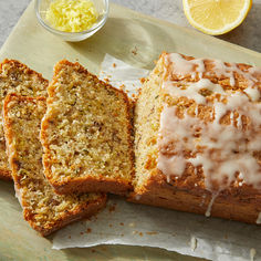 a loaf of lemon bread with icing on top and slices cut off from it