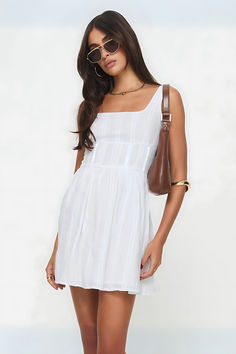 Elevate your style with the Lorinda White Mini Dress—a chic blend of sophistication and allure. Perfect for garden parties, summer soirées, and beach vacations. Features delicate lace detailing and a flattering silhouette. Embrace timeless beauty and make every moment unforgettable.#SummerStyle #ChicFashion #LaceLove #DressToImpress #ElegantAttire Square Neck Mini Dress For Daywear, Cotton Square Neck Sundress For Day Out, Cotton Sundress With Smocked Bodice And Square Neck, Cotton Summer Sundress With Square Neck, Cotton Square Neck Sundress For Daywear, Summer Cotton Sundress With Square Neck, Cotton Square Neck Sundress With Smocked Back, Cotton Sundress With Square Neck, Square Neck Cotton Dress For Day Out