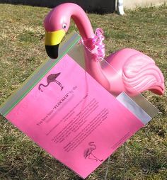 a pink flamingo shaped like a piece of paper with a note attached to it