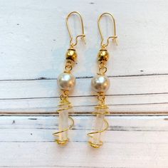 "Intriguing 3 tiered boho earrings with tiny white crystals wired wrapped and sophisticated faux pearls. Earrings have a 2.75\" drop with gold plated, nickel free ear wires. These lightweight beauties will be the perfect finishing touch to complete your boho look!" Gold Wire-wrapped Crystal Earrings, Adjustable Wire Wrapped Crystal Earrings, Gold Wire Wrapped Beaded Earrings, Gold Wire Wrapped Adjustable Crystal Earrings, Gold Wire Wrapped Dangle Linear Earrings, Gold Wire Wrapped Crystal Earrings, Adjustable Gold Wire Wrapped Crystal Earrings, Bohemian Gold Beaded Pearl Earrings, Bohemian Gold Crystal Earrings Wire Wrapped