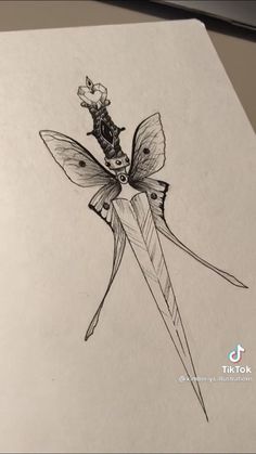 a pencil drawing of a butterfly on a pair of scissors with a flower in the middle