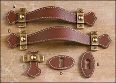 two brown leather straps with brass hardwares and one has a keyhole on each side